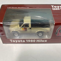 BM Creations 1/64 Toyota Hilux, Ivory RHD w/ Extra Wheels & Bumpers