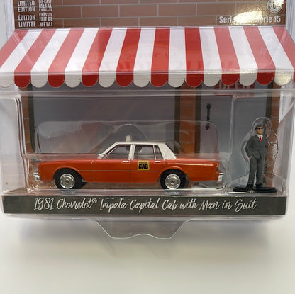 1/64 Greenlight The Hobby Shop Series 15 1981 Chevrolet Impala Capital Cab w/ Man In Suit Orange