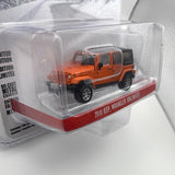 Greenlight Hollywood 1/64 Cold Pursuit 2010 Jeep Wrangler Unlimited  Orange