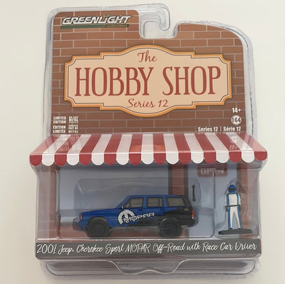 Greenlight 1/64 The Hobby Shop 2001 Jeep Cherokee Sport Mopar Off-Road W/ Race Car Driver Blue